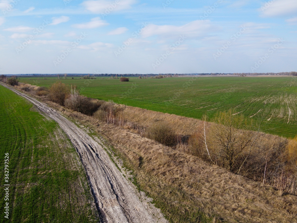 Abandoned land reclamation canal in the field, aerial view. Agricultural landscape.