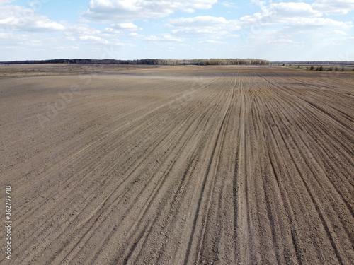 Treated farm field  aerial view. Agricultural land.