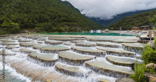 4K, 10bit, YUV422 timelapse of Lanyuegu waterfall or Blue moon valley landscape with Jade Dragon Yulong snow mountain background, Lijiang, Yunnan, China