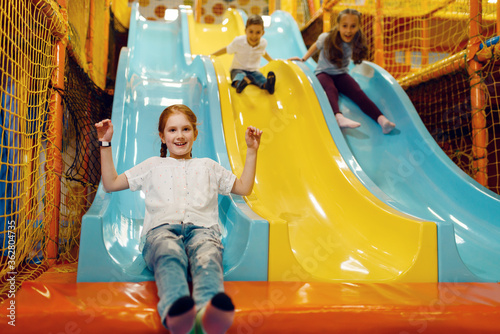 Children ride down the hill, entertainment center