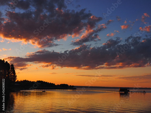 Sunset, summer, beautiful clouds at sunset. Pier on the big Kama river. Ural, Russia, Perm Territory, Elovo.