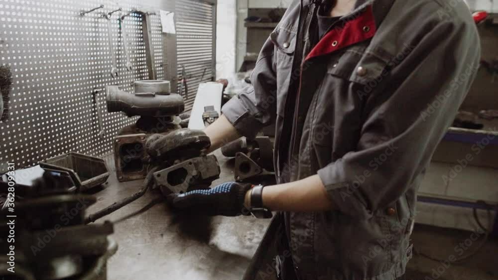 Auto mechanic repairing a car in a workshop.car repair concept Auto mechanic repairing a car in a workshop.car repair concept