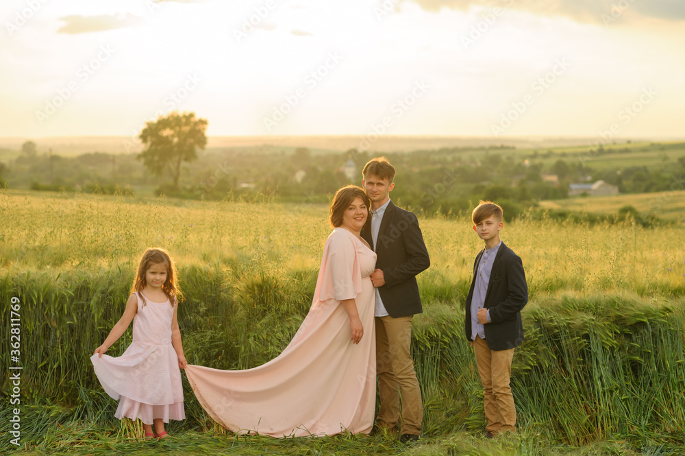 Father mother, son and daughter in a wheat field. Father mother, son and daughter in a wheat field.