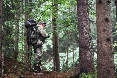 Active healthy man hiking in beautiful forest