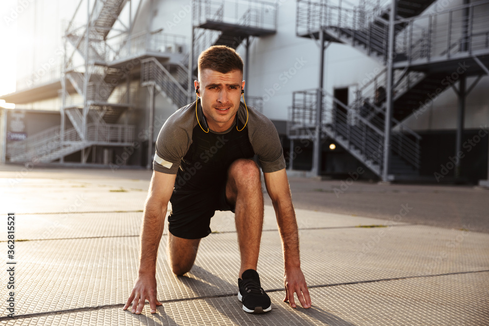 Image of unshaven caucasian sportsman doing exercise while working out Image of unshaven caucasian sportsman doing exercise while working out