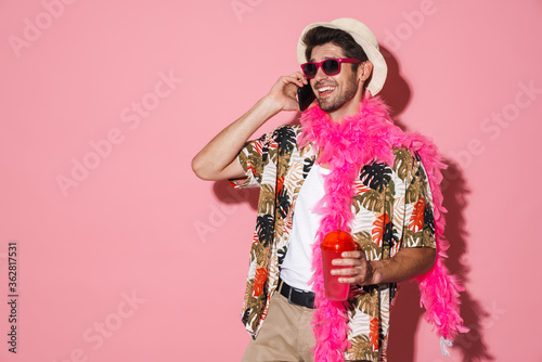 Portrait of smiling man talking on cellphone while drinking soda © Drobot Dean