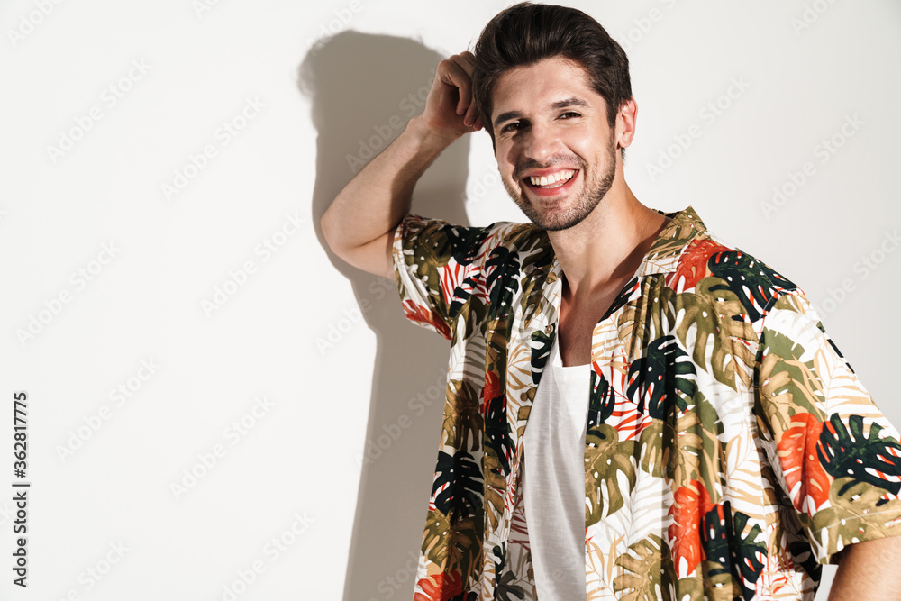 Portrait of cheerful young man smiling and posing on camera Portrait of cheerful young man smiling and posing on camera