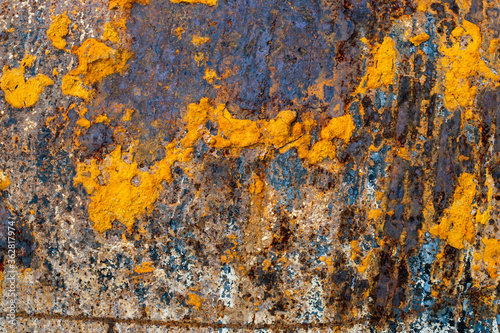 A metal surface covered with pieces of orange rust.