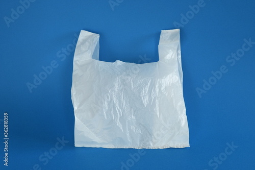 White disposable plastic bag on blue background