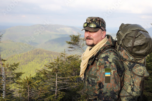 Active healthy man hiking in beautiful forest