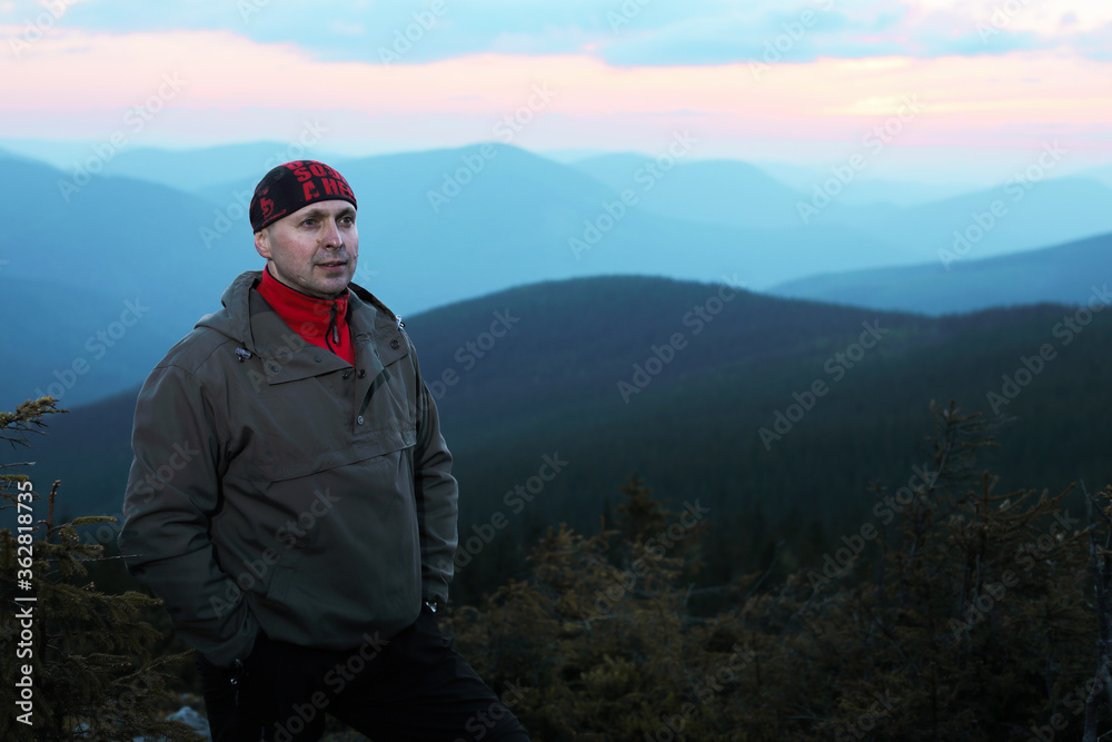 Naklejka premium Man on top of mountain. Conceptual scene.