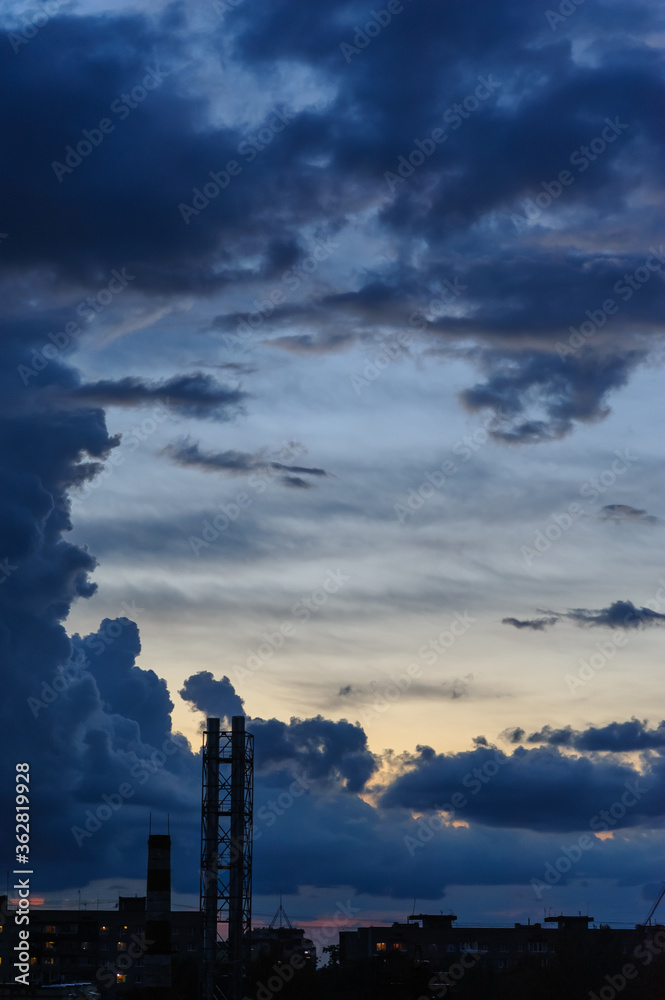 Dark blue storm clouds over city in rainy season Dark blue storm clouds over city in rainy season
