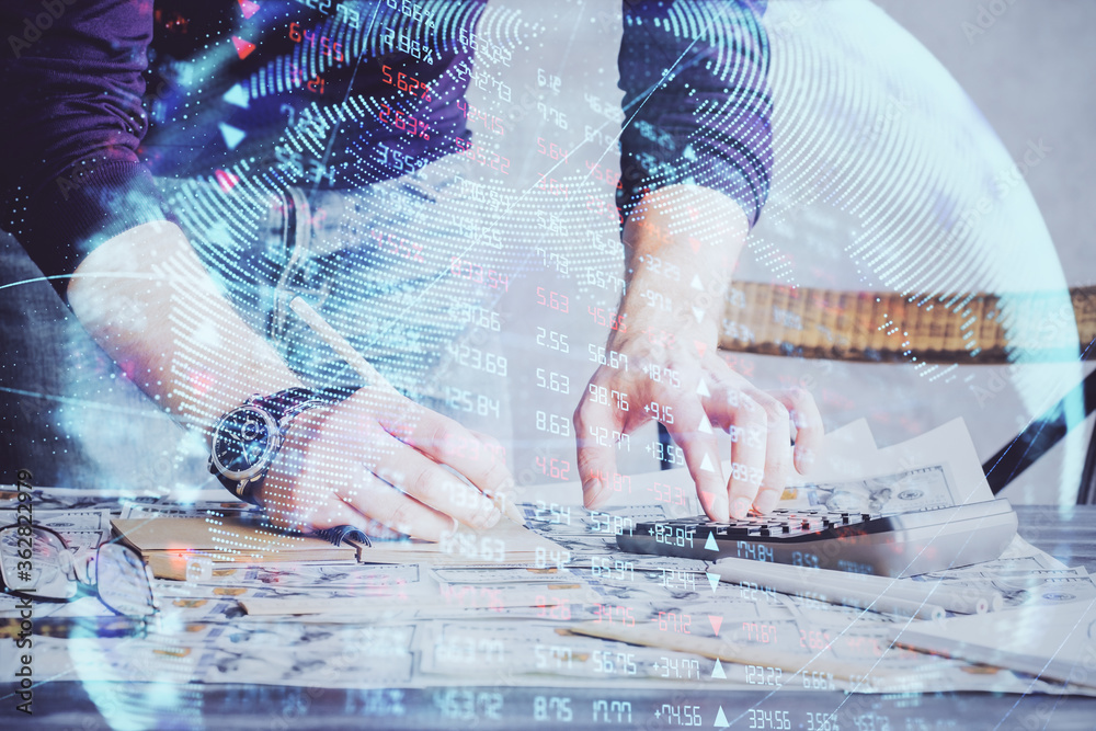 Double exposure of Man writing in notepad with business icons on background. Double exposure of Man writing in notepad with business icons on background.