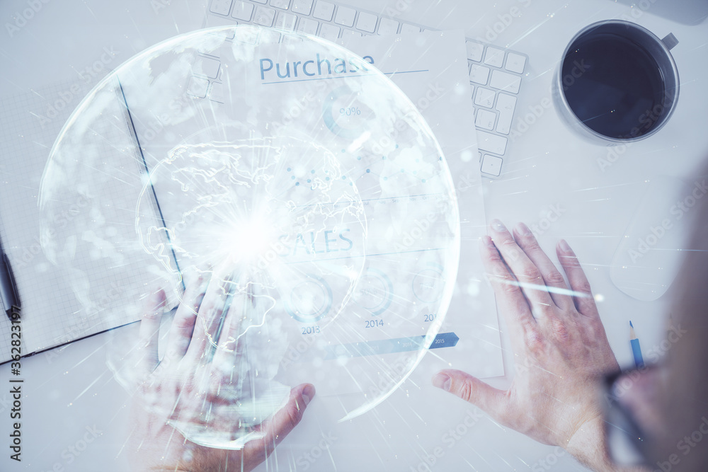 Double exposure of hands and notepad with business icons. Double exposure of hands and notepad with business icons.