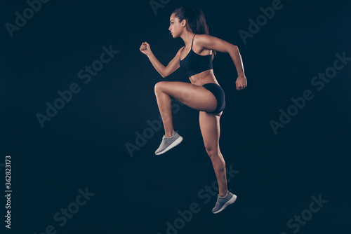 Full size profile photo short sport suit lady practicing sprint run jogger inspired to win race isolated black background photo