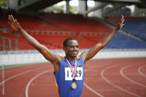 Man with gold medal celebrating his success