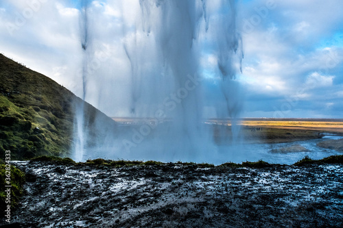 Seljalandsfoss, a magic waterfall in South Iceland seen from behind