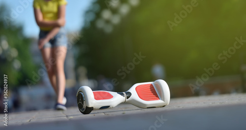 Girl child injured her elbow while falling off a hoverboard while riding in a park photo