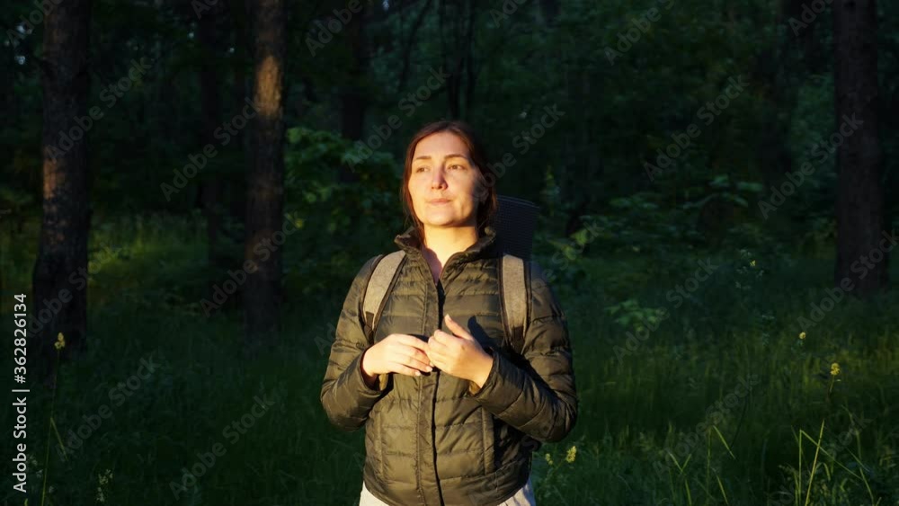 young woman with a backpack was lost in the forest. Screams for help. young woman with a backpack was lost in the forest. Screams for help.