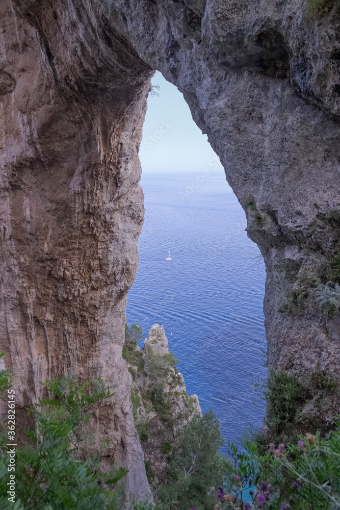 The natural arch in Capri, Italy. A view looking back to the elephant shaped, natural arch from the coastal path on the island of Capri.