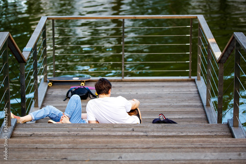 A young couple is relaxing on the pier