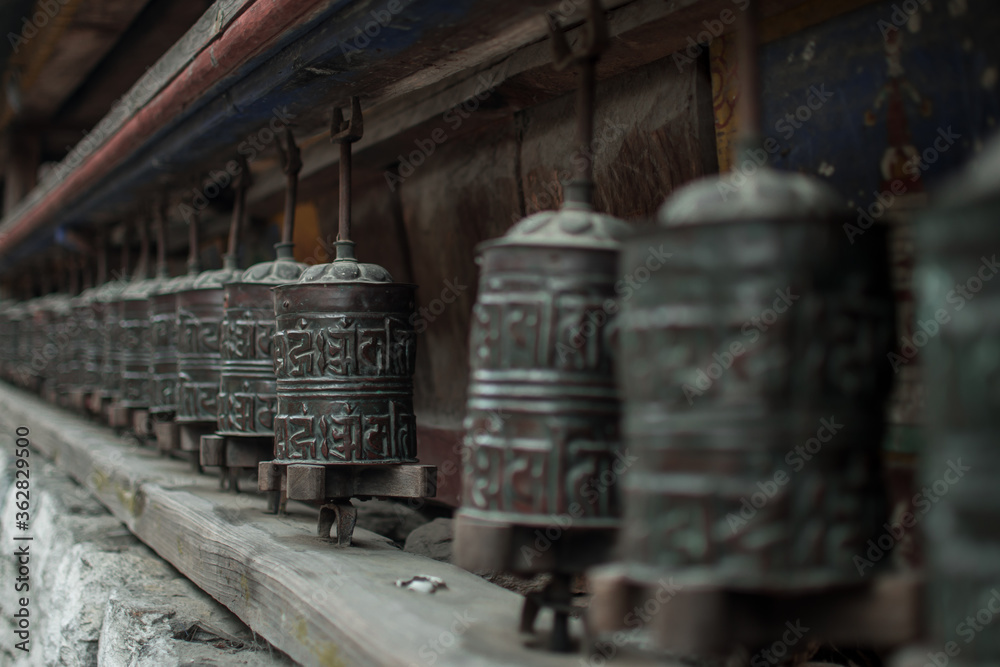 Buddhist prayer wheels in a long row, Annapurna circuit, Nepal Buddhist prayer wheels in a long row, Annapurna circuit, Nepal