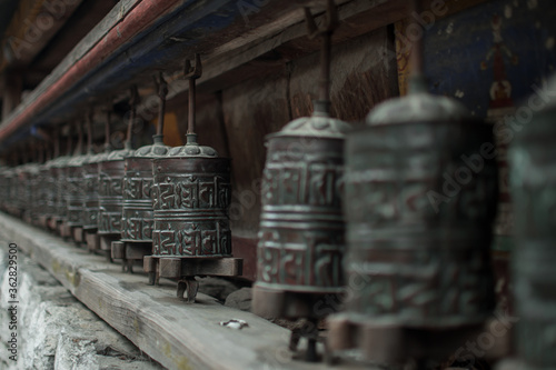 Buddhist prayer wheels in a long row, Annapurna circuit, Nepal