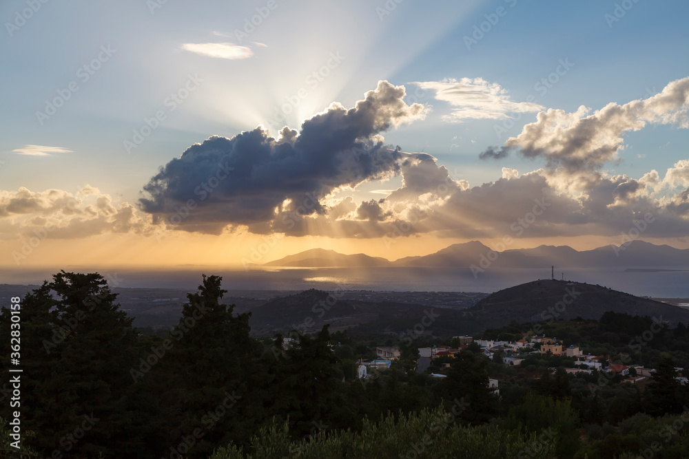 Sunset view with clouds and sun rays from Zia Village, in Kos, Greece.