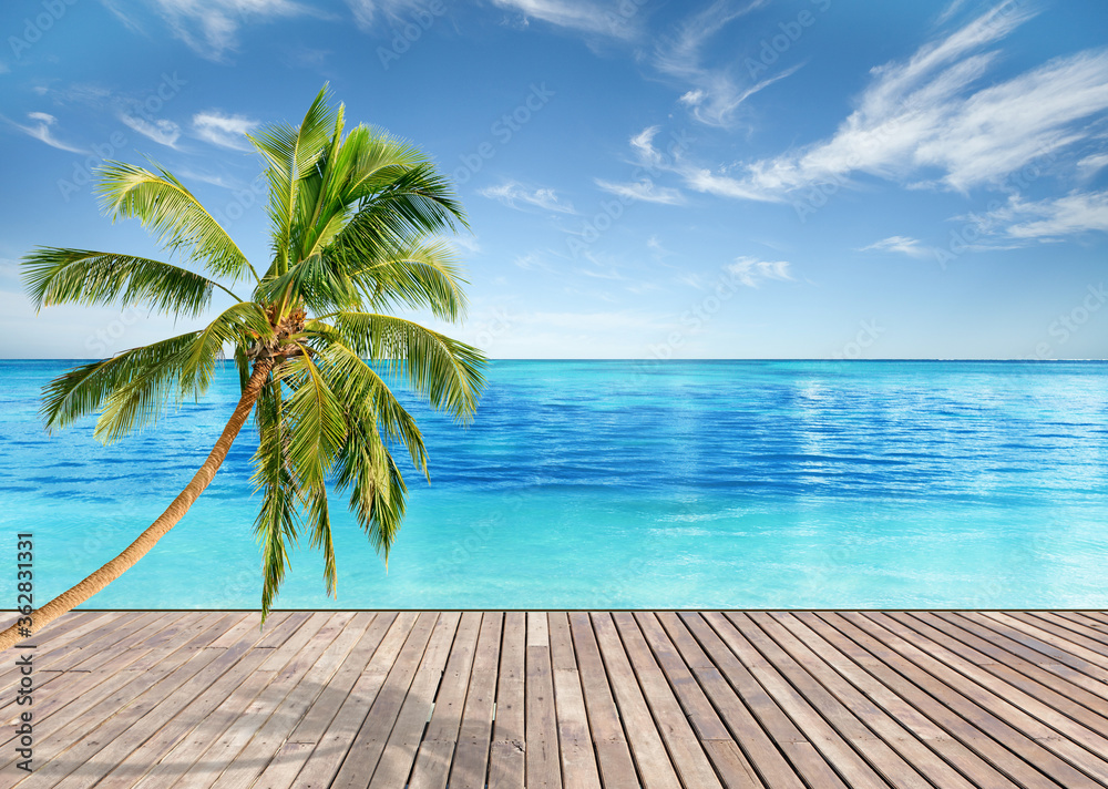 Tropical beach with empty wooden platform and bright blue sky and crystal clear waters