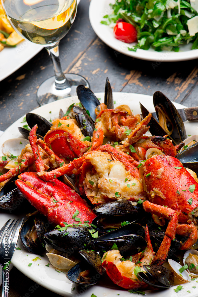 Lobster, mussels, clams and shrimp. Classic Italian restaurant entree favorite. Seafood stew baked in wood fire over and severed with olive oil, lemons and garnished with Italian parsley.