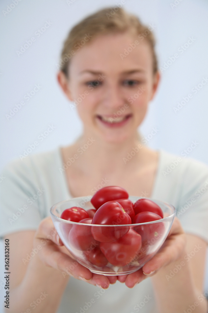Woman with a bowl of tomatoes Woman with a bowl of tomatoes