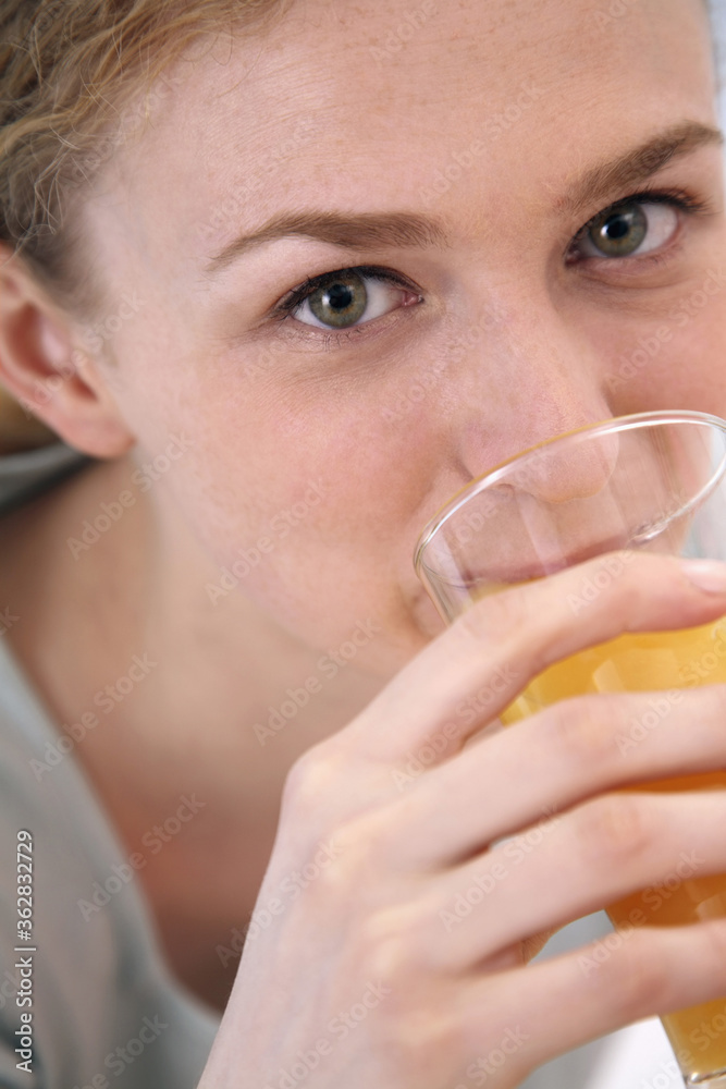 Woman drinking a glass of orange juice Woman drinking a glass of orange juice