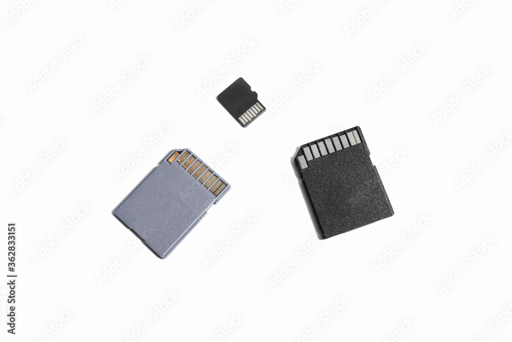 three SD memory cards on a white background, selective focus three SD memory cards on a white background, selective focus