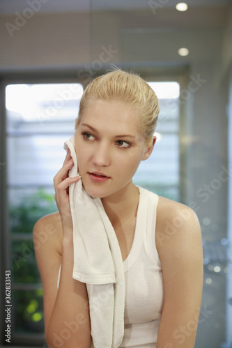 Woman wiping herself with a towel