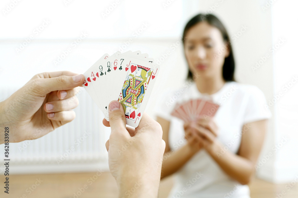 Couple spending their free time playing cards Couple spending their free time playing cards