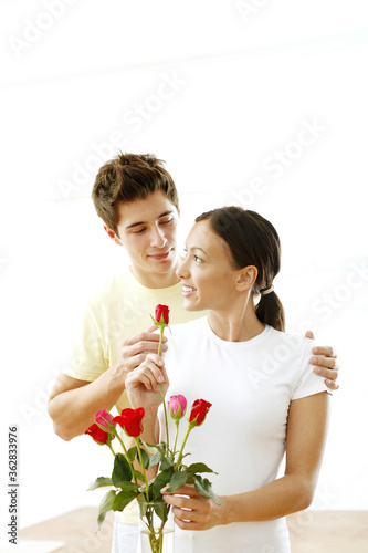 Couple with a vase of roses © ImageHit