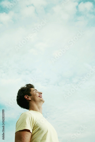 Young man laughing while looking up