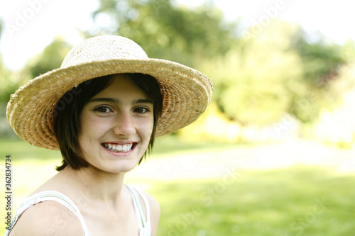 Teenage girl with hat smiling at the camera