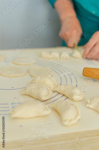 process of sculpting home-made pierogi. Grandma prepares a national Ukrainian dish - vareniki.