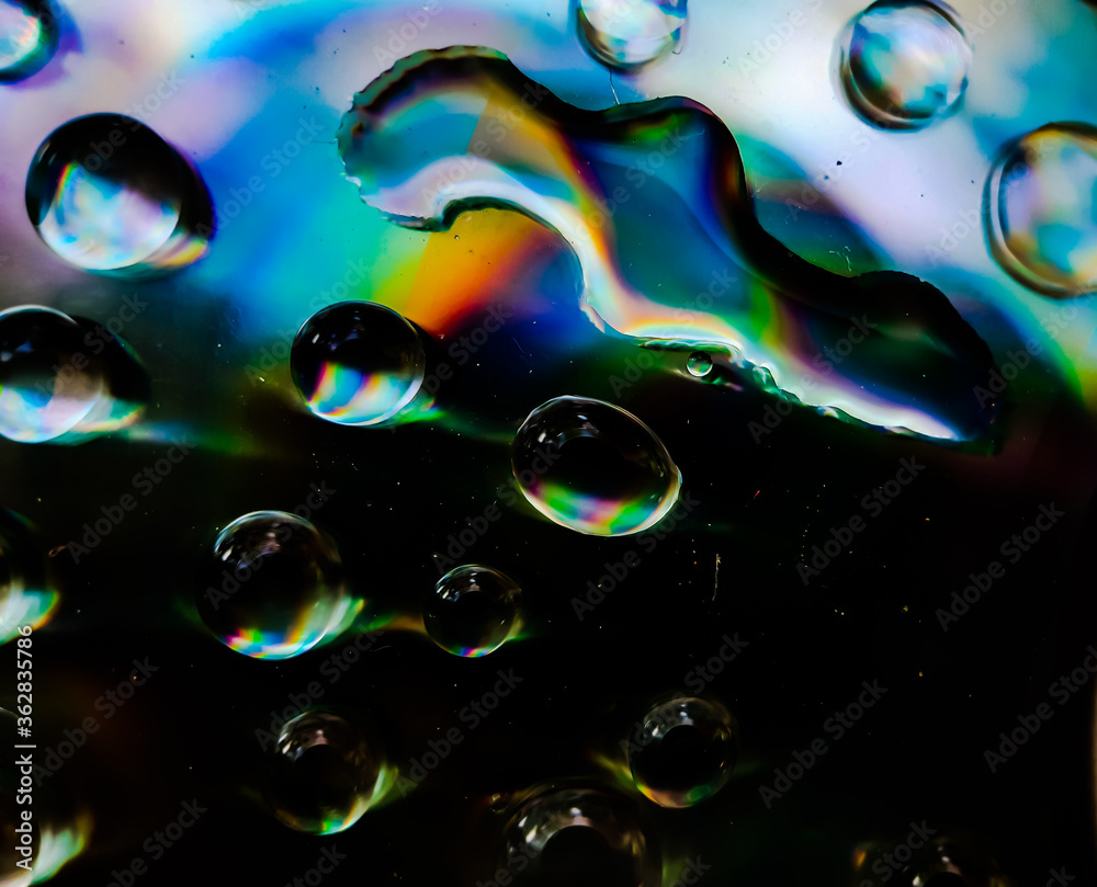 Water is dripping on the CD discs and red,blue and yellow lights are coming out. Water is dripping on the CD discs and red,blue and yellow lights are coming out.