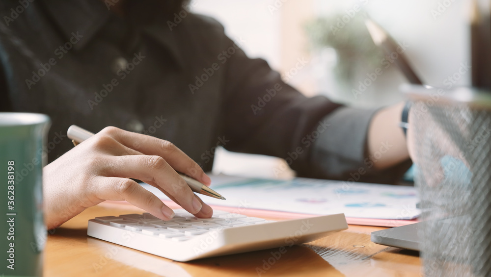 Woman use calculator for finance and accounting Analyze financial budget Woman use calculator for finance and accounting Analyze financial budget