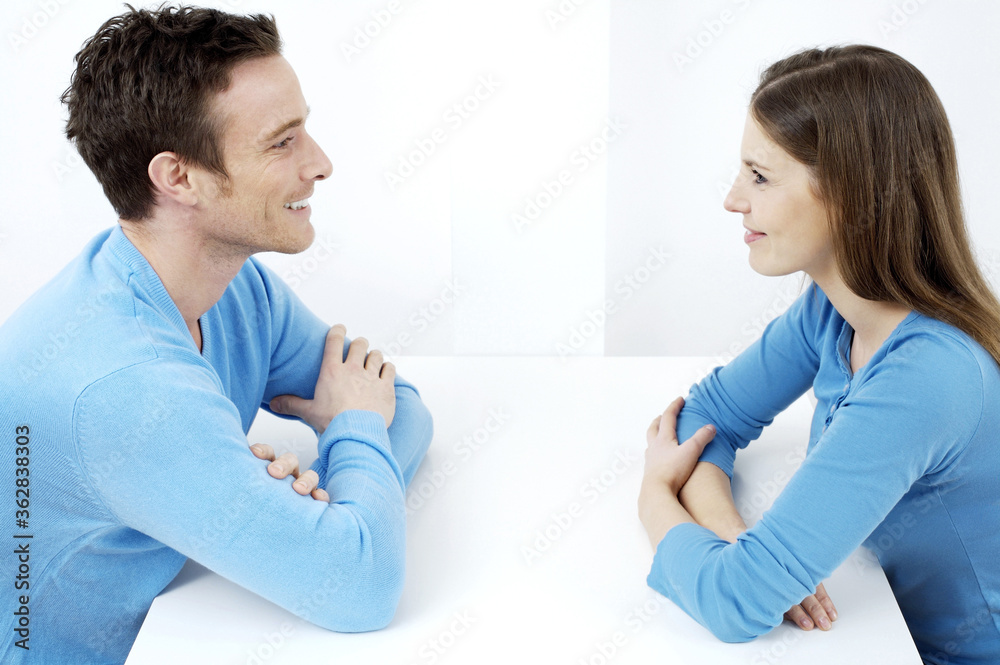 Couple smiling while looking at each other Couple smiling while looking at each other