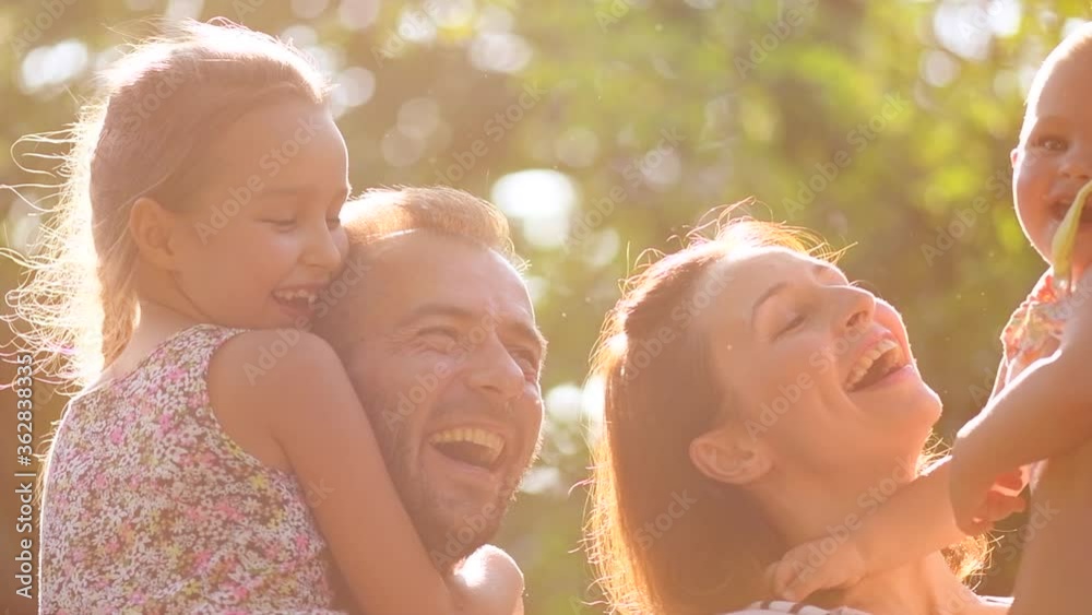 Happy Young big Family with children enjoying nature together, outdoors. Parents with kids. Slow motion. 4K UHD