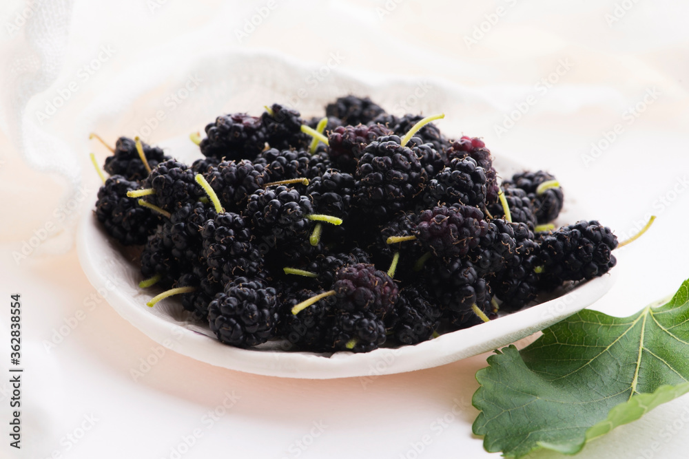 Pile of mulberry isolated on white plate Pile of mulberry isolated on white plate
