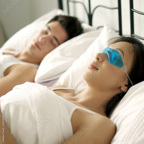 Couple sleeping comfortably on the bed