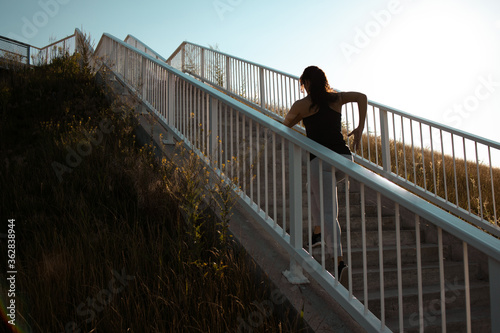 Fitness woman she is running up the stairs