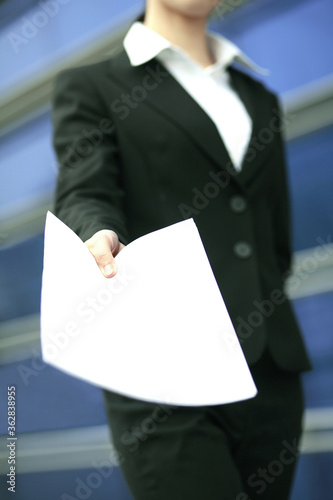 Businesswoman holding a blank paper