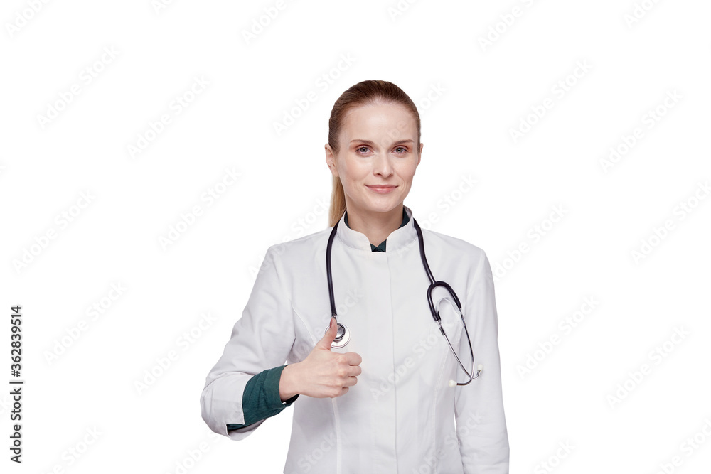 Beautiful female doctor in medical coat showing thumbs up gesture. Beautiful female doctor in medical coat showing thumbs up gesture.