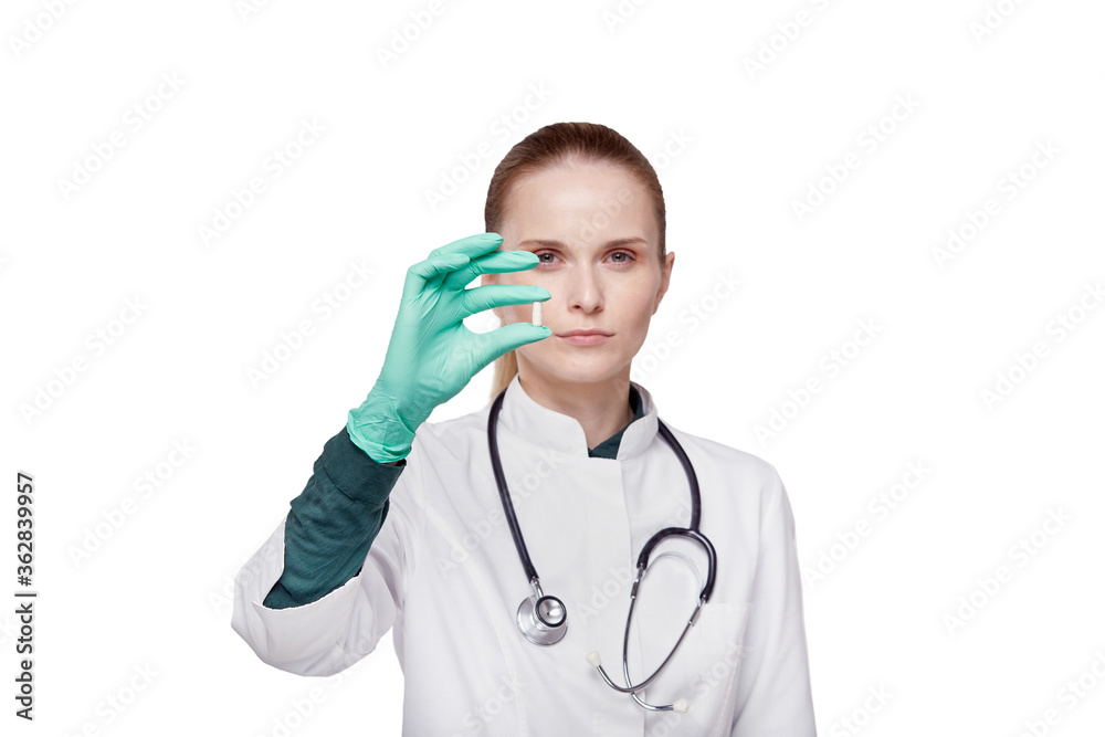Close-up of a doctor hand in surgical gloves. Holds a medicine in his hand