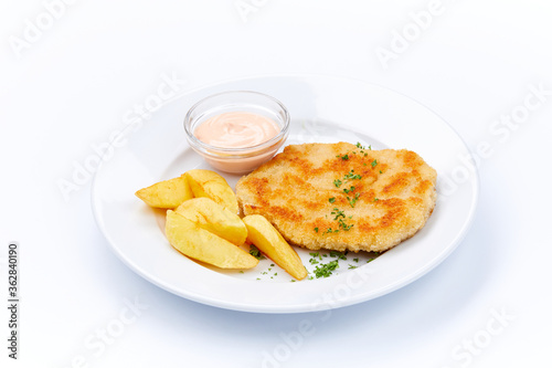 schnitzel with potatoes on white